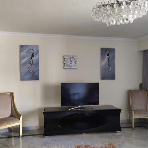 a living room with a black table and two chairs at Apartment at 4 Seasonz San Stefano in Alexandria