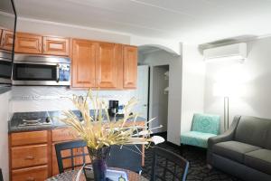 a kitchen and living room with a table and a couch at Periwinkle Inn in Cape May