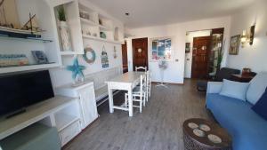 a living room with a blue couch and a table at La Font Lovely apartment LEstartit 400 meter from the beach in L'Estartit
