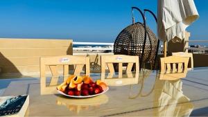 a bowl of fruit on a table on a balcony at Alam B&B in Marsa Alam City