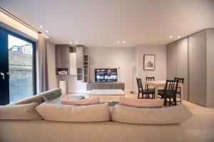 a living room with a couch and a dining room at Chic Studio w/ Balcony - Newly refurbished in London