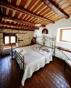 a bedroom with a large bed in a building at Helikon -la dimora del viandante- in Montalbano Elicona