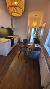 a kitchen and dining room with a table and chairs at Ferienwohnung Karpe in Schwedt +3 photos