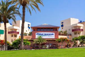 a hotel with palm trees in front of a building at Hotel Best Jacaranda in Adeje +68 photos
