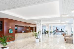 a lobby with potted plants in a building at Hotel Best Tenerife in Playa de las Americas