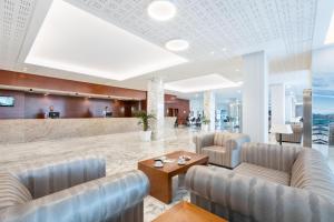 a lobby of a hotel with chairs and a table at Hotel Best Tenerife in Playa de las Americas