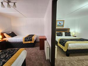 Giường trong phòng chung tại Hotel Forjadores del Cabo de Hornos