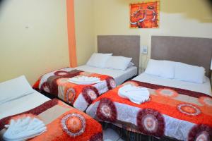 מיטה או מיטות בחדר ב-Hostal Pacifico Chinandega