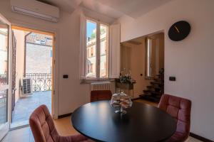 a dining room with a table and chairs at Cortevecchia 59 in Ferrara