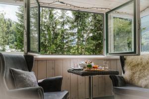 a room with two chairs and a table and two windows at Ferienwohnungen Badbruckerweg- Bad Gastein in Bad Gastein