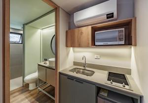 a small bathroom with a sink and a toilet at The Somos Flats Central Poblado in Medellín