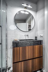a bathroom with a sink and a mirror at Hs4U Ricasoli Luxury apartment near Duomo N.1 in Florence