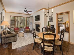 a dining room and living room with a table and chairs at Arrowhead Village Condo - 104 Aspenwood Lodge in Edwards