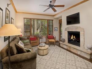 a living room with a couch and a fireplace at Arrowhead Village Condo - 104 Aspenwood Lodge in Edwards