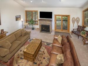 a living room with a couch and a fireplace at Coldstream Townhome 19 in Vail