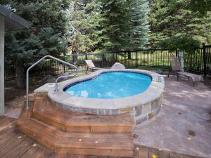 a small swimming pool with a deck and a bench at Coldstream Townhome 19 in Vail