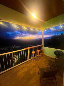 a balcony with a view of a sunset at Orosi Mountain Lodge in Orosí