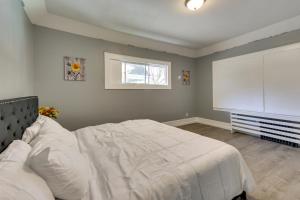 a bedroom with a white bed and a window at Chic Newark Vacation Rental 3 Mi to Airport! in Newark