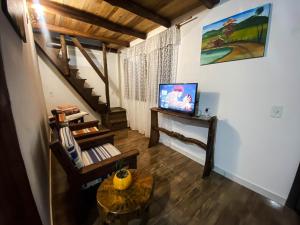 a living room with a staircase and a table at Pouso das Águias in Nova Veneza