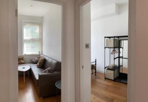 a living room with a couch and a table at Central Location 2 bed flat, Zone II, London NW6 in London