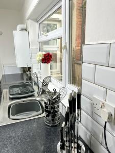 a kitchen counter with a sink and a window at Spacious Town House in Wyken