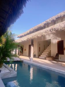 a resort with a swimming pool in front of a building at Casa Santa Maria Tatajuba in Tatajuba