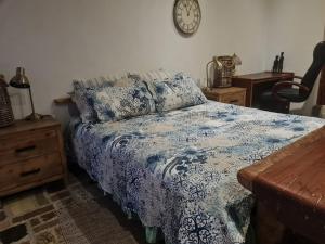 a bedroom with a bed and a clock on the wall at Rockscape in Sandown +12 photos
