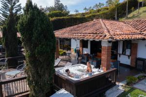 two people in a hot tub in a backyard at CASA CAMPESTRE MONTECARLO Guatapé- desayuno a pareja in Guatapé