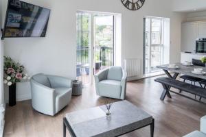 a living room with two chairs and a table at The Sidings, Luxury Penthouse, Haworth in Haworth