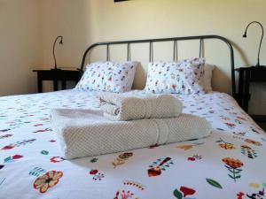 a bed with two towels and pillows on it at Casa Niebla - Zona Rural - Alajeró in Alajeró +27 photos