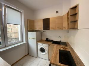 a small kitchen with a washing machine and a window at Apartament WHITE in Kielce +7 photos