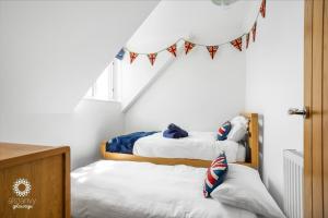 two bunk beds in a room with a flag banner at The Lookout in Hythe