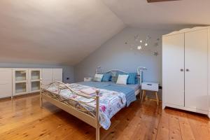 a bedroom with a bed and a white cabinet at Casa Antico in Premantura