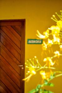 a sign that says harrowma next to a door at Luamar Chalés in São Miguel do Gostoso