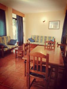a living room with a table and chairs and a couch at Casa Carolina 2 in Playa de Santiago