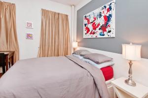 a bedroom with a bed and a lamp and a window at great studio apt new york city in New York