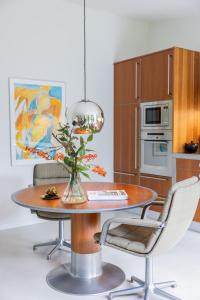 a kitchen with a table with a vase of flowers on it at It Merkelân in Beetsterzwaag