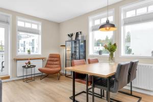a dining room with a table and chairs at Two bedroom downtown apartment with balcony in Akureyri