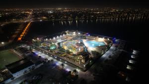 an overhead view of a building with a pool at night at Sea Club Resort in Dammam