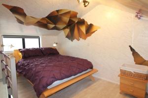 a bedroom with a bed with a geometric design on the wall at Fantastic Waterside apartment in Brighton Marina in Brighton & Hove