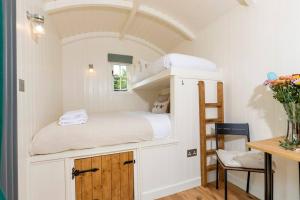 a small room with a bunk bed and a desk at Dilly Hill Den in Stanhope