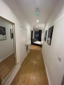 a hallway with a room with a bed and a mirror at Tranquil 1 BR Retreat in Piccadilly VR4 in London +10 photos
