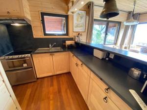 a kitchen with wooden cabinets and a black counter top at Chalet St Lary Pla d'Adet in Saint-Lary-Soulan