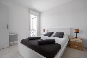 a bedroom with a large bed with two pillows on it at T2 Entre la plage et le Vélodrome - Clim/Parking in Marseille