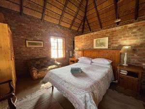 una camera con letto e muro di mattoni di Schoemanshof a Potchefstroom