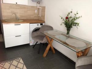 a kitchen with a table and a vase of flowers at Studio Sara in Iaşi