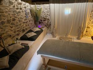 a room with two beds and a stone wall at Chambre d'hotes Bessiard in Laparrouquial +18 photos