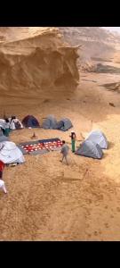 a group of tents on a sandy beach at Excursion dakhla tour in Dakhla