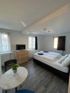 a bedroom with a large bed and a table at Haus zum Rütli in Chur
