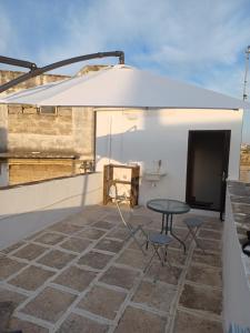 a patio with a table and chairs on a roof at La Casetta in Surbo